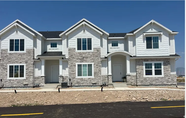 Modern townhome exterior featuring stone veneer and horizontal siding
