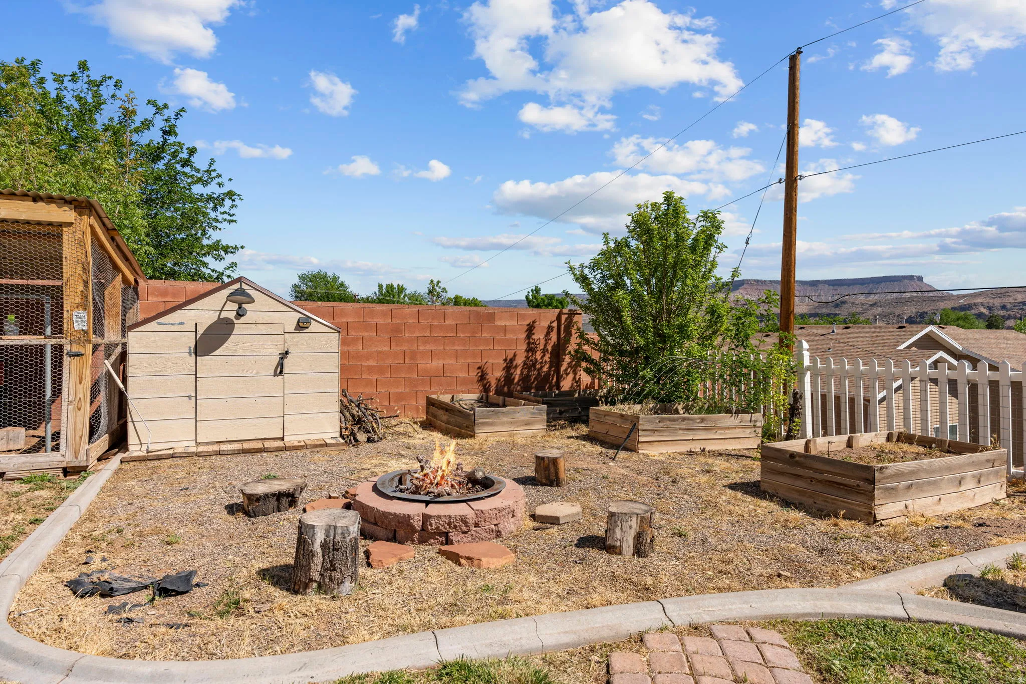 Fenced backyard featuring a shed