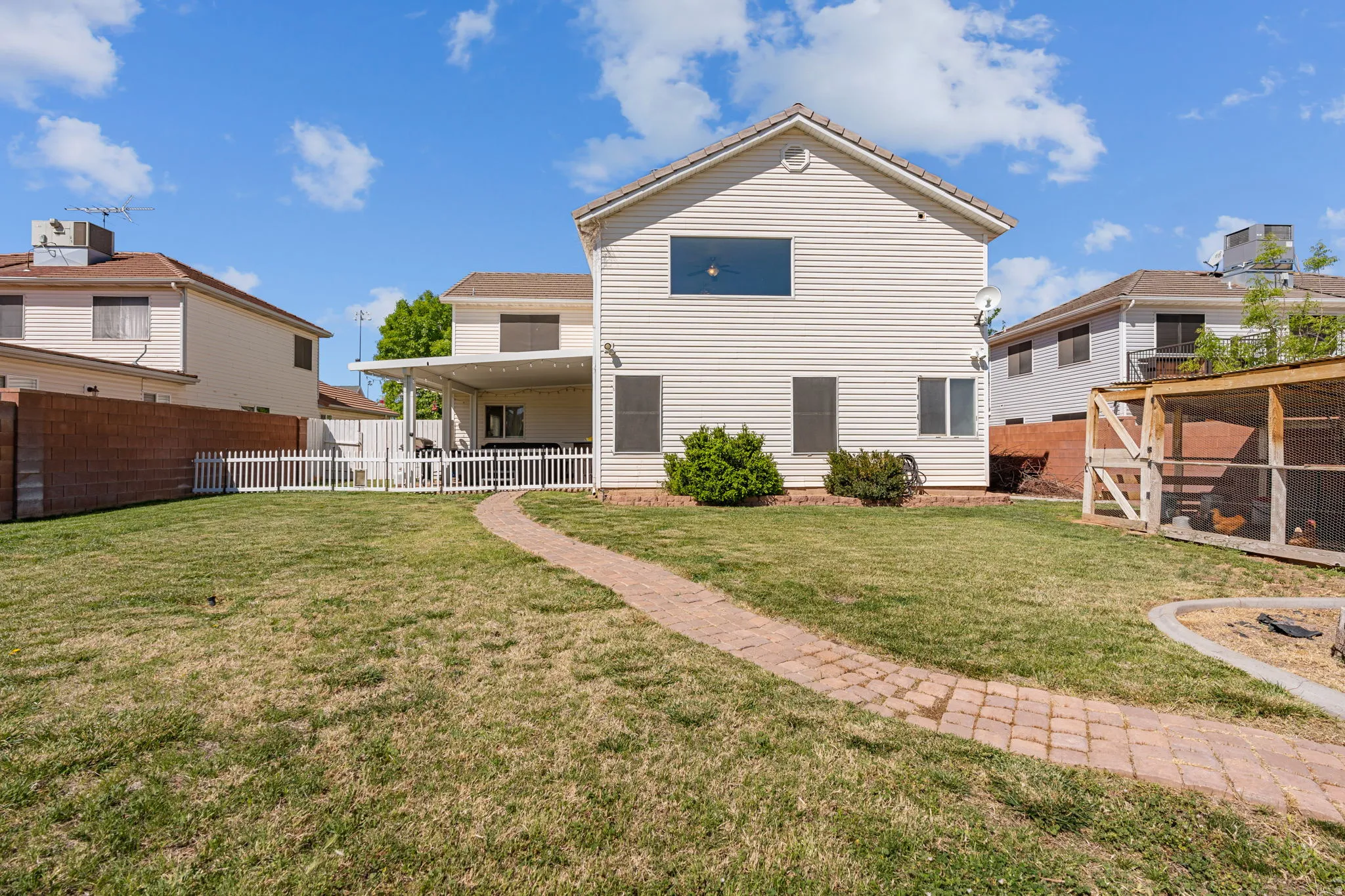 Rear view of property featuring a fenced backyard