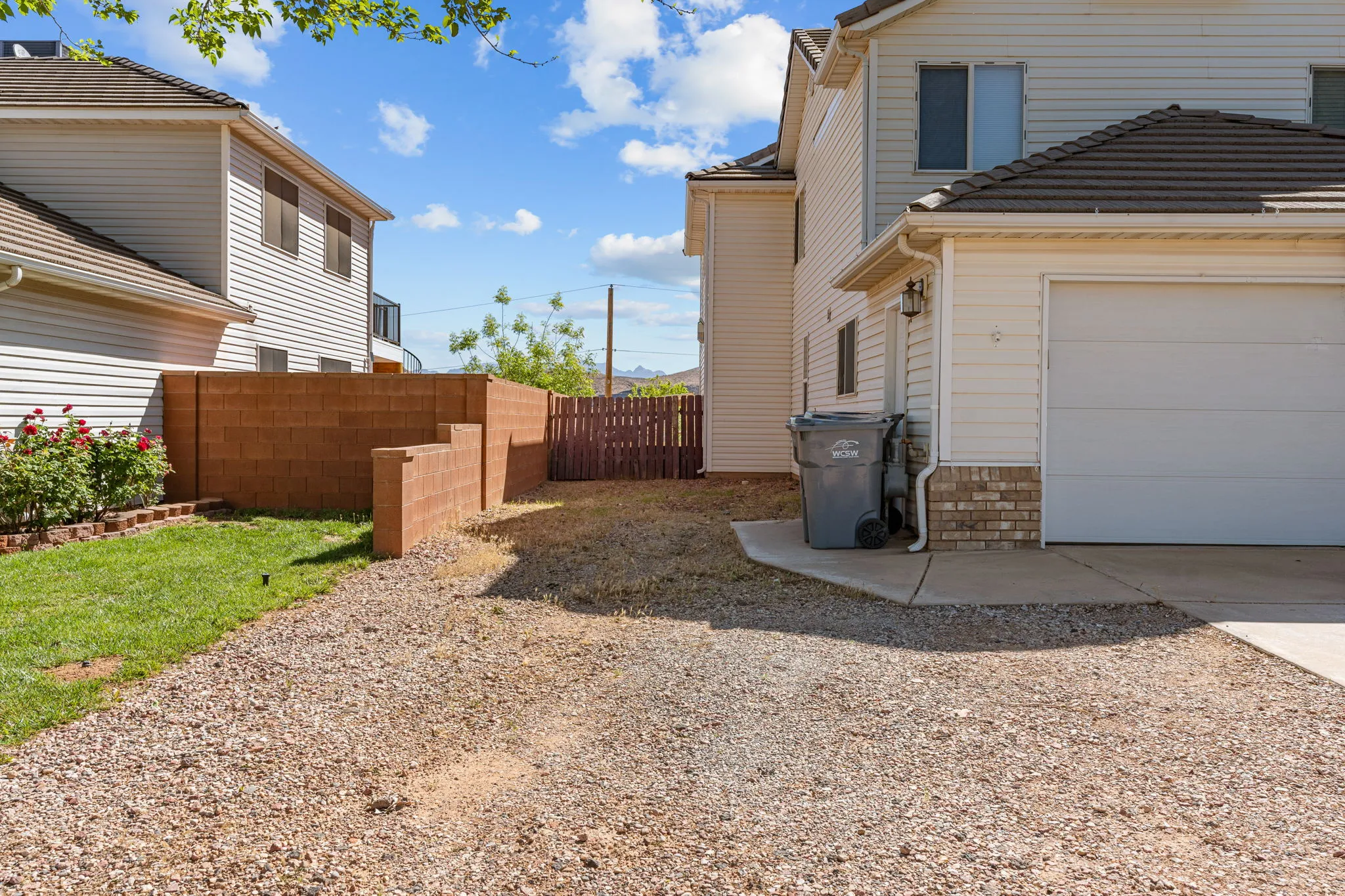 View of side of home with driveway and a garage