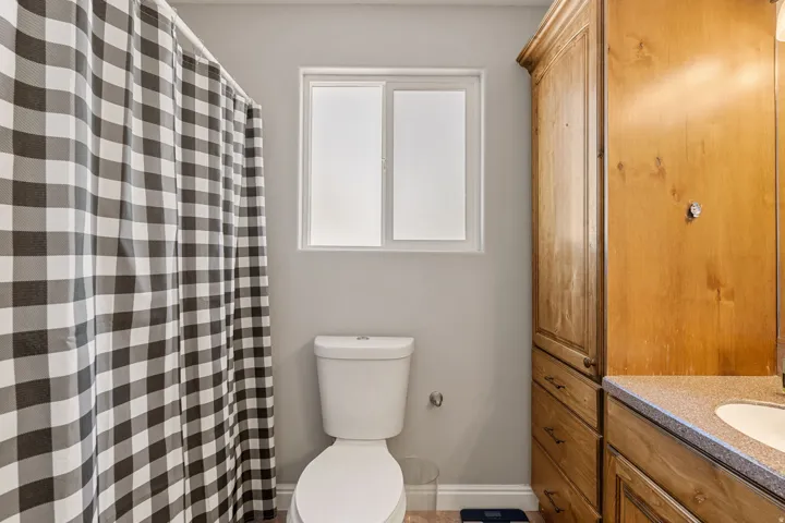Full bath featuring vanity and curtained shower