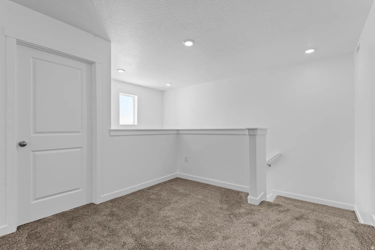 Basement with carpet, a textured ceiling, and recessed lighting