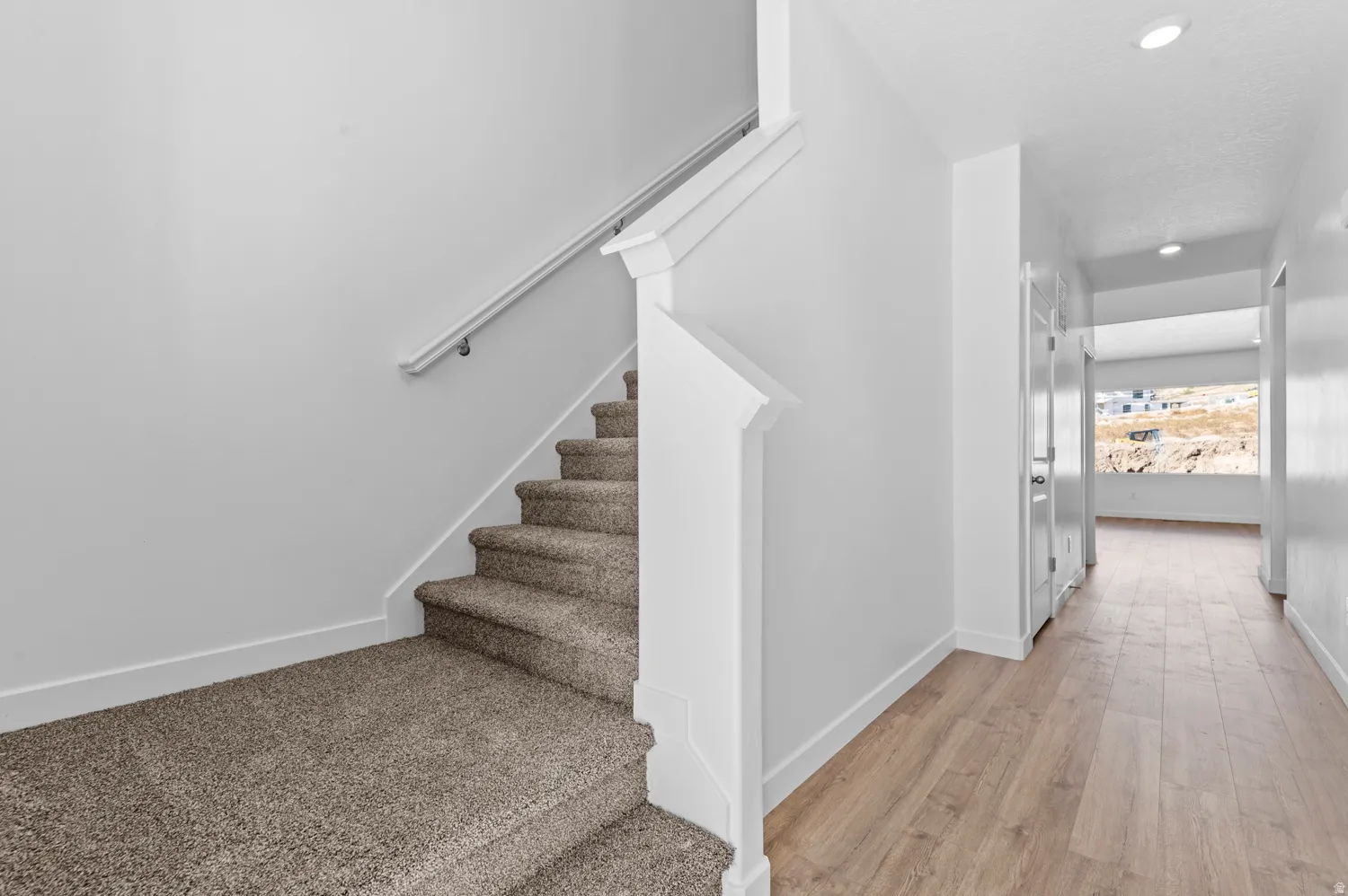 Staircase featuring recessed lighting and wood finished floors