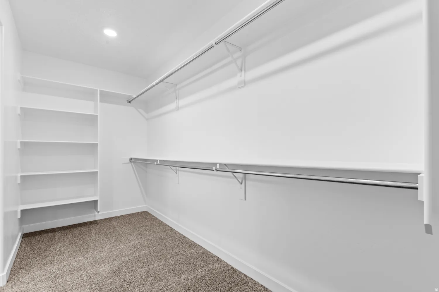 Walk in closet with dark carpet