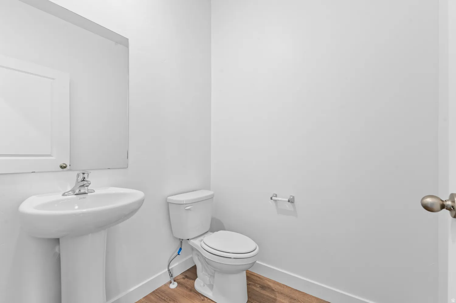 Bathroom featuring light wood-type flooring and toilet