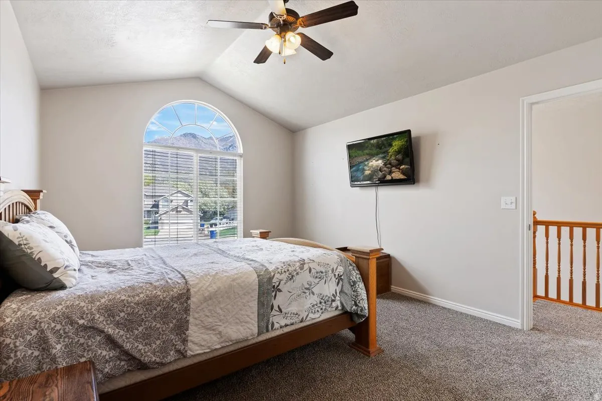 Bedroom featuring dark colored carpet and ceiling fan