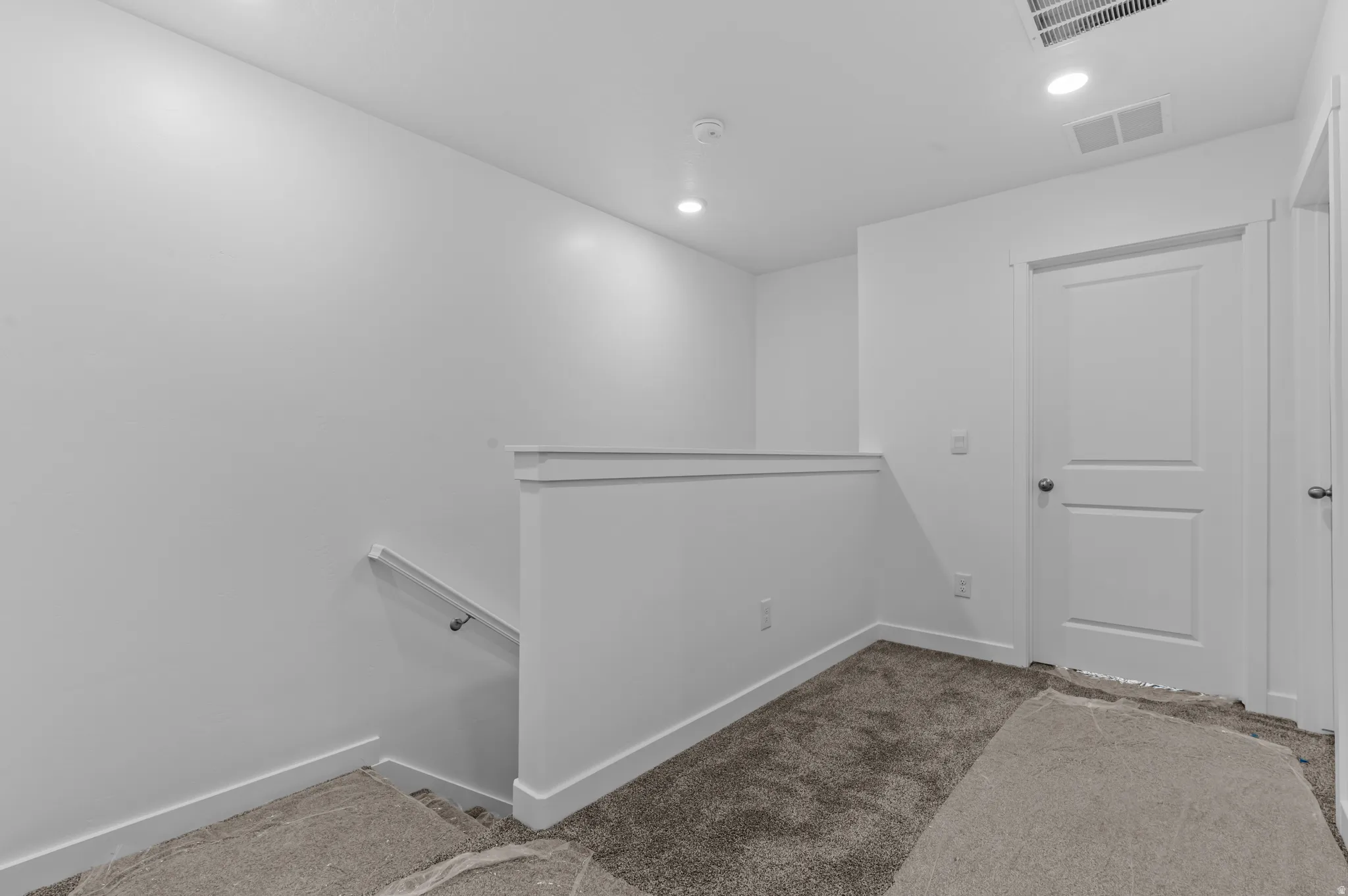 Corridor featuring an upstairs landing, carpet floors, and recessed lighting