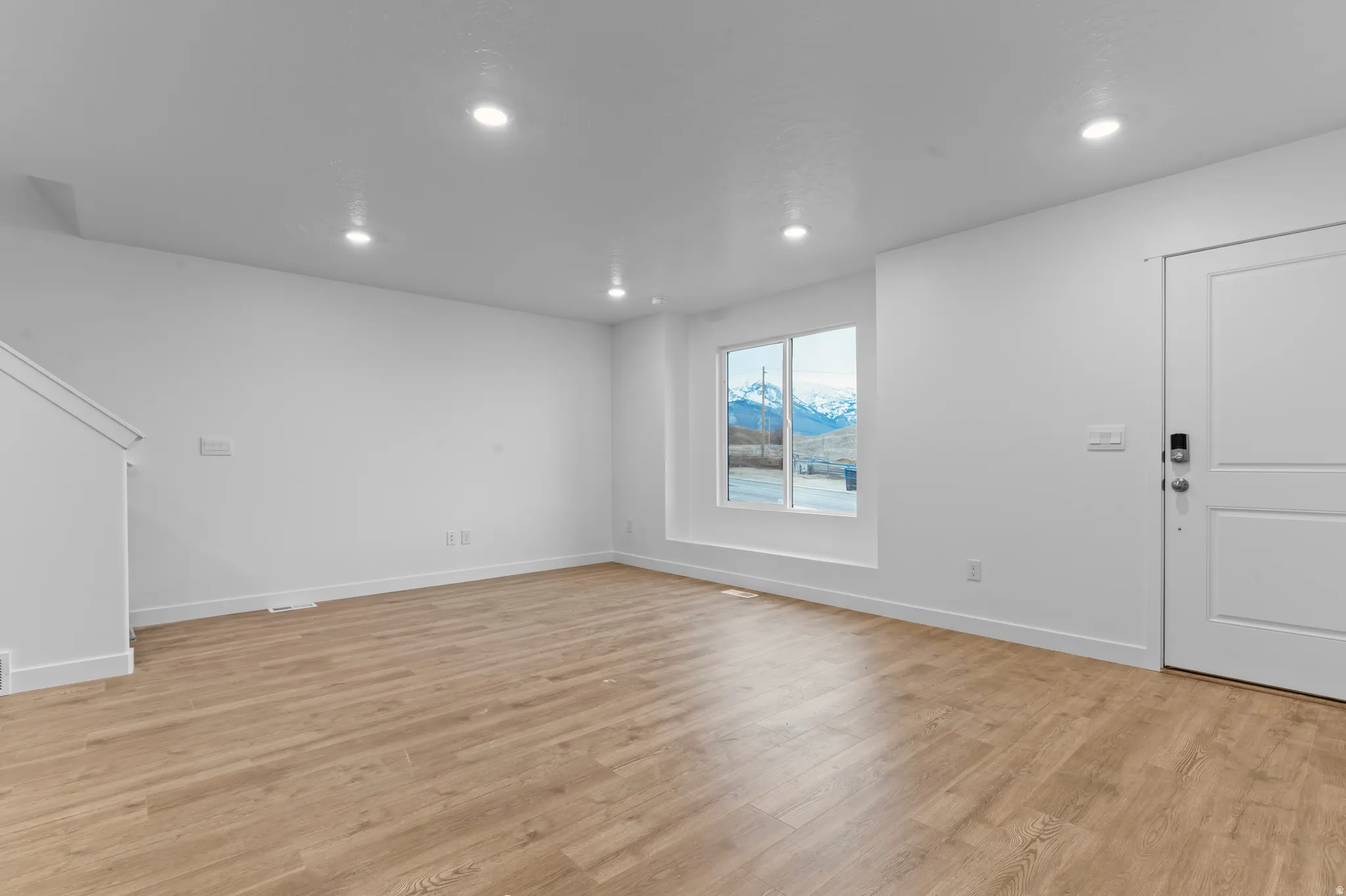 Foyer entrance with recessed lighting and light wood finished floors