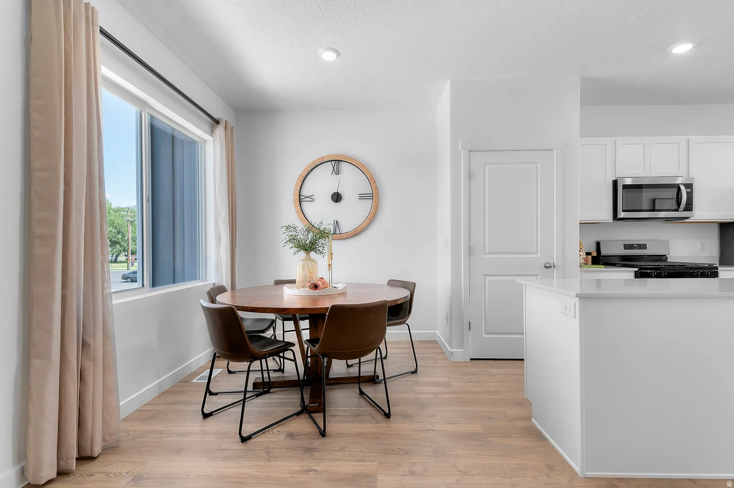 Dining room featuring light wood finished floors and baseboards