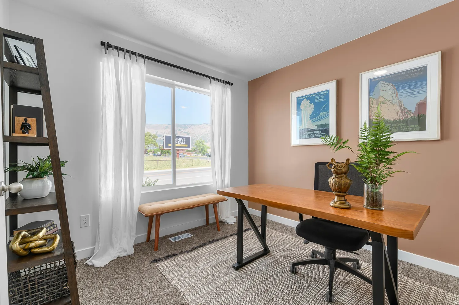Office space with light carpet, a textured ceiling, and a mountain view