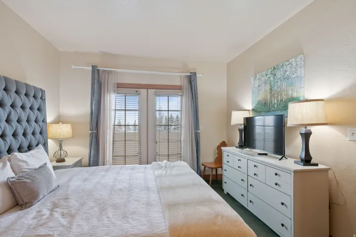 Bedroom featuring dark carpet