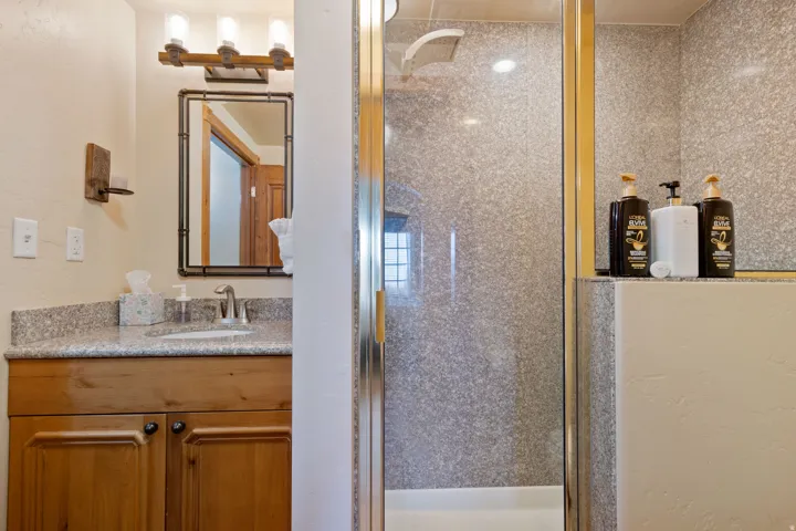 Bathroom with a stall shower and vanity