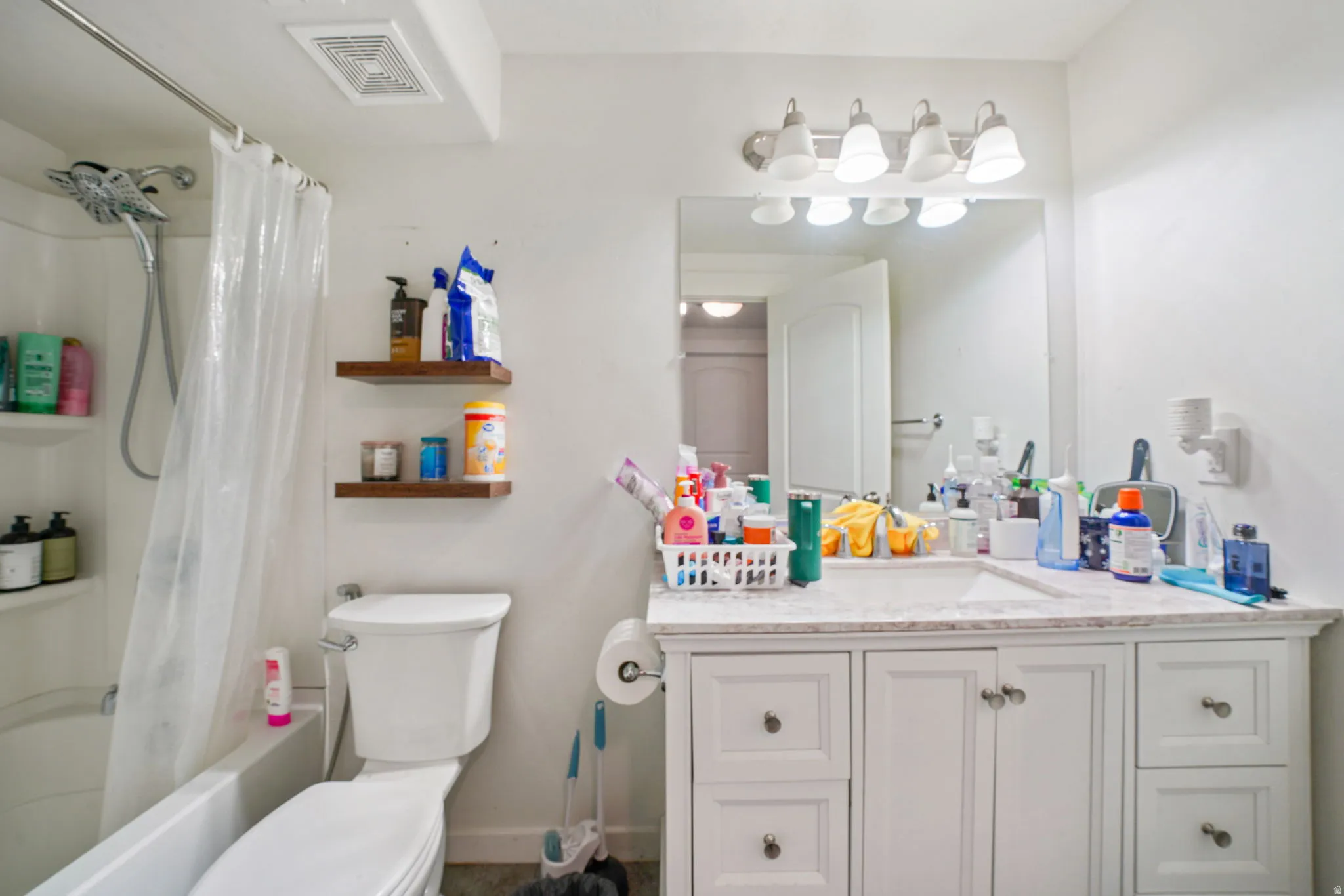 Full bath with vanity and shower / bath combination with curtain