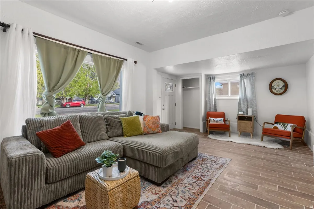 Living room featuring wood finish floors and a textured ceiling