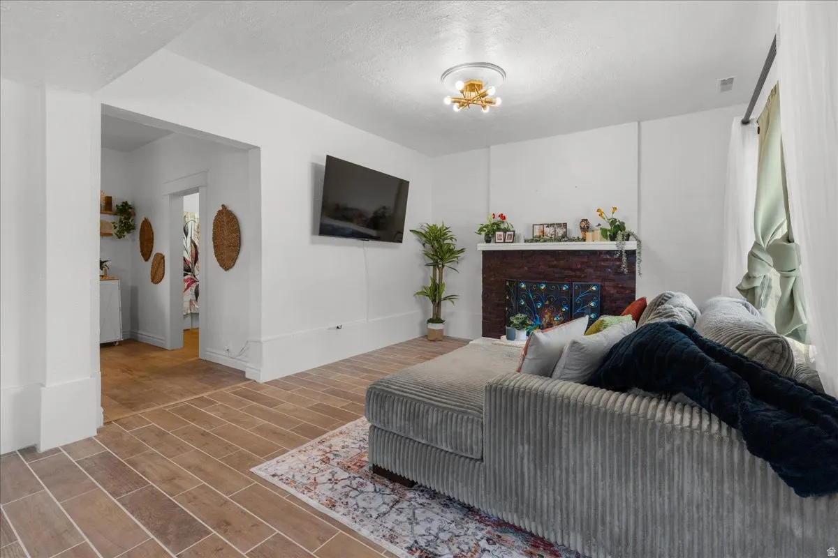 Living room featuring wood finish floors and a textured ceiling