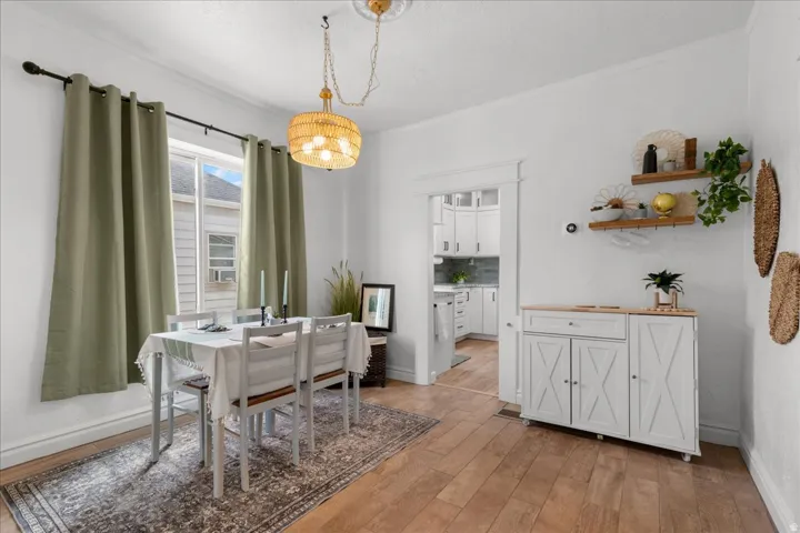 Dining area with light wood-style floors and crown molding