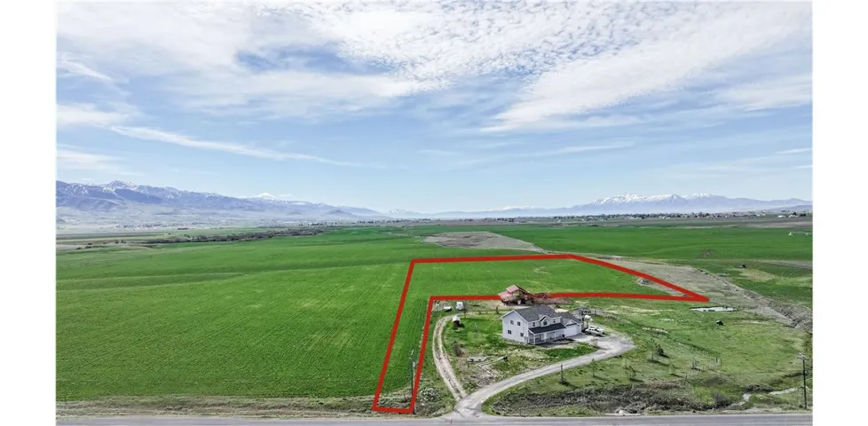 Overview of rural landscape with property boundaries highlighted, and a mountainous background-property boundaries are estimate only