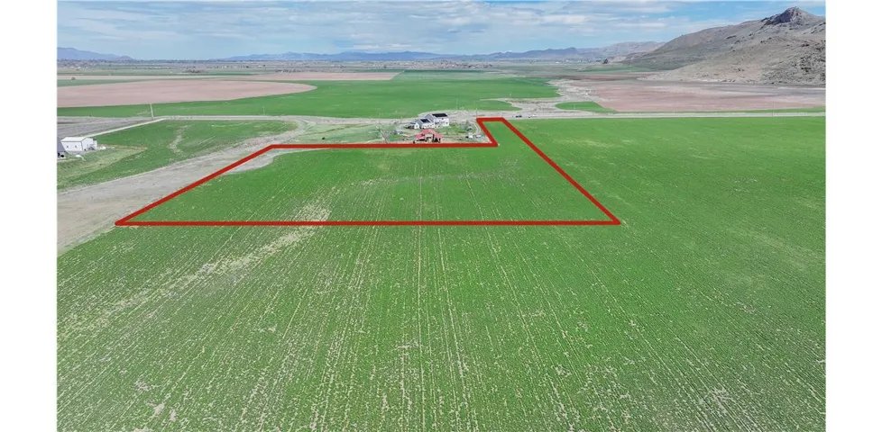 Aerial view of sparsely populated area with property boundaries highlighted, a mountain backdrop-boundary is estimate only