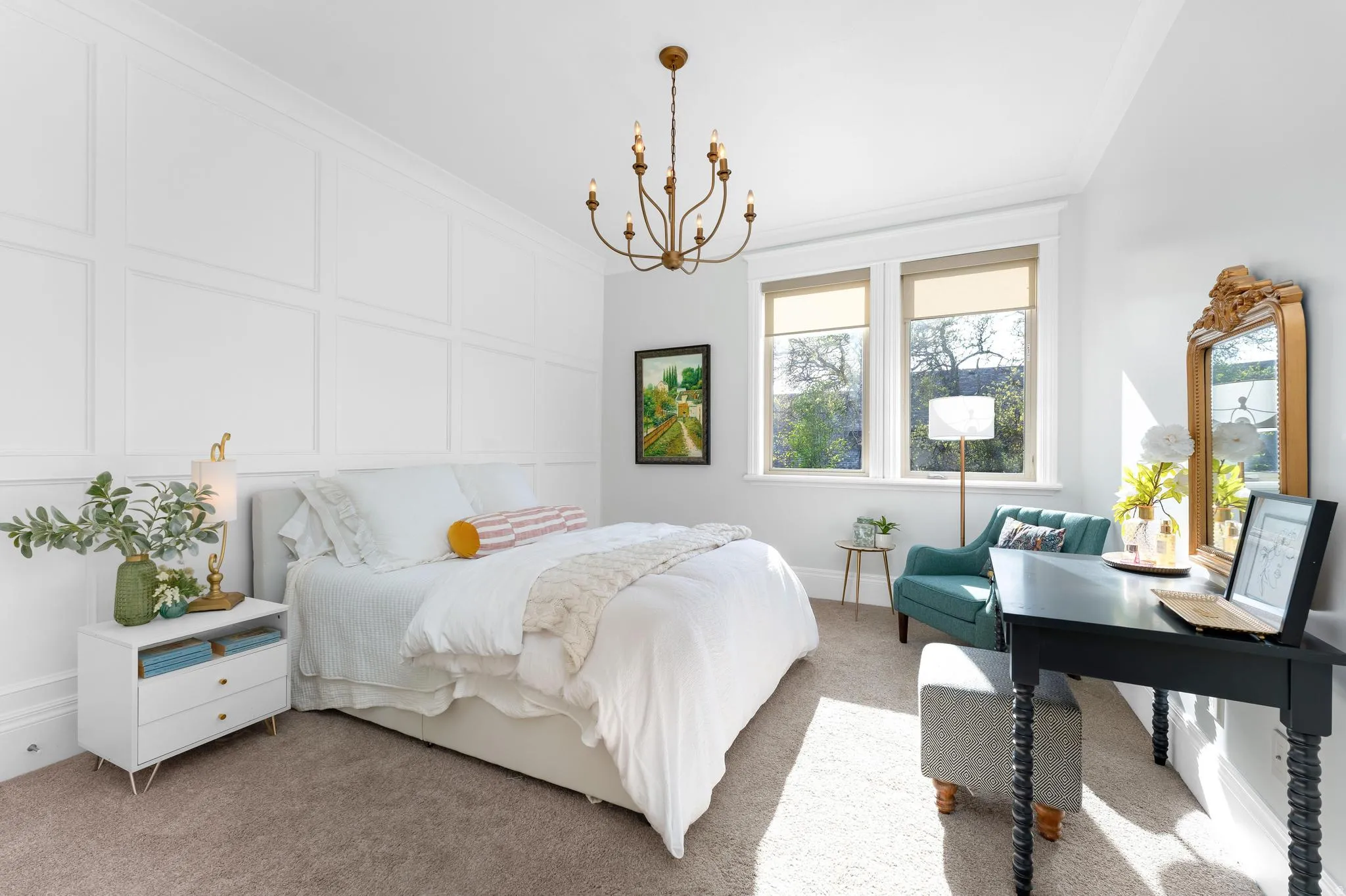Bedroom featuring a decorative wall, light carpet, suspended lighting, and ornamental molding