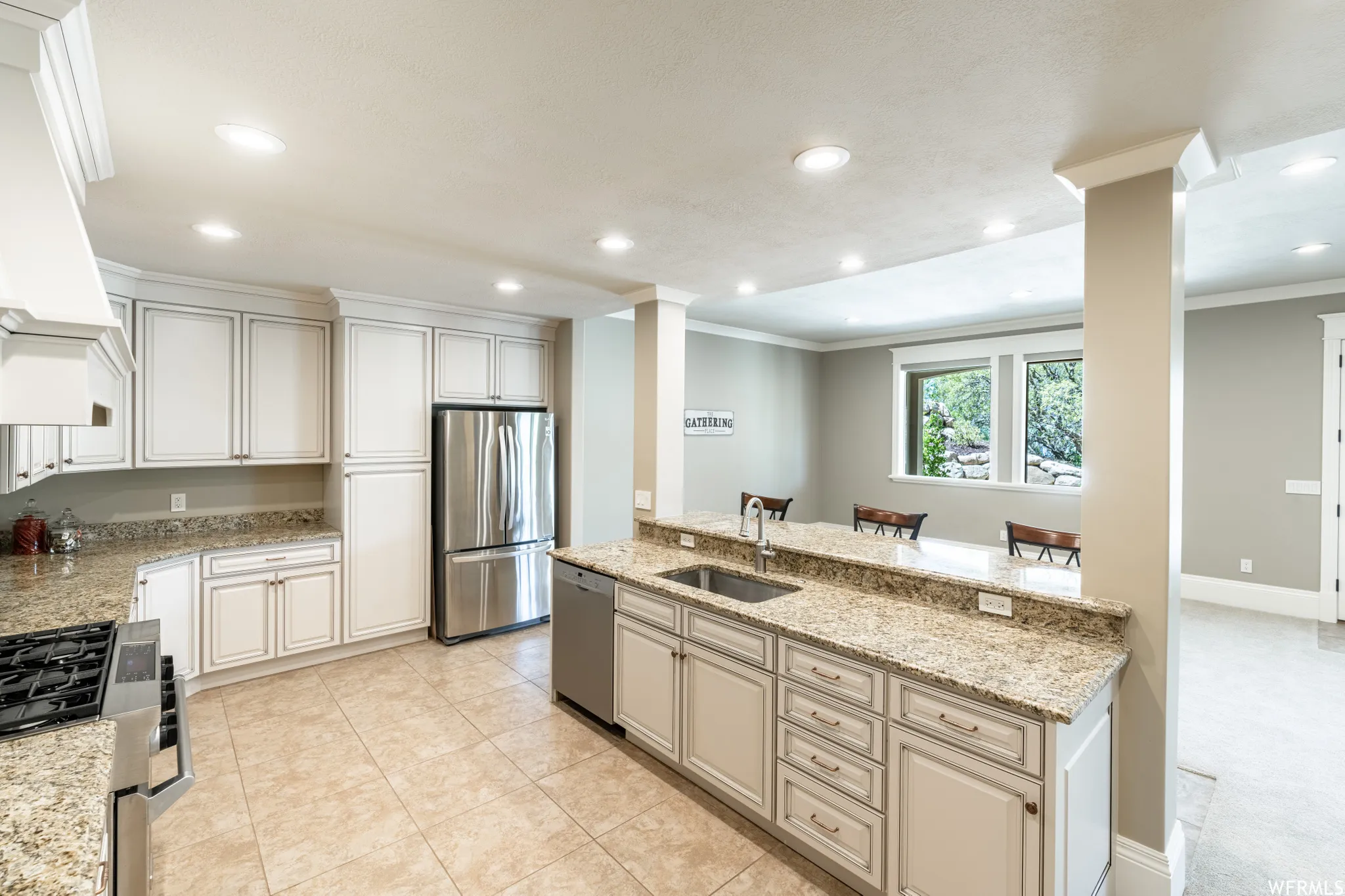 Spacious kitchen featuring extensive cabinetry, granite countertops, stainless steel appliances, and tile flooring