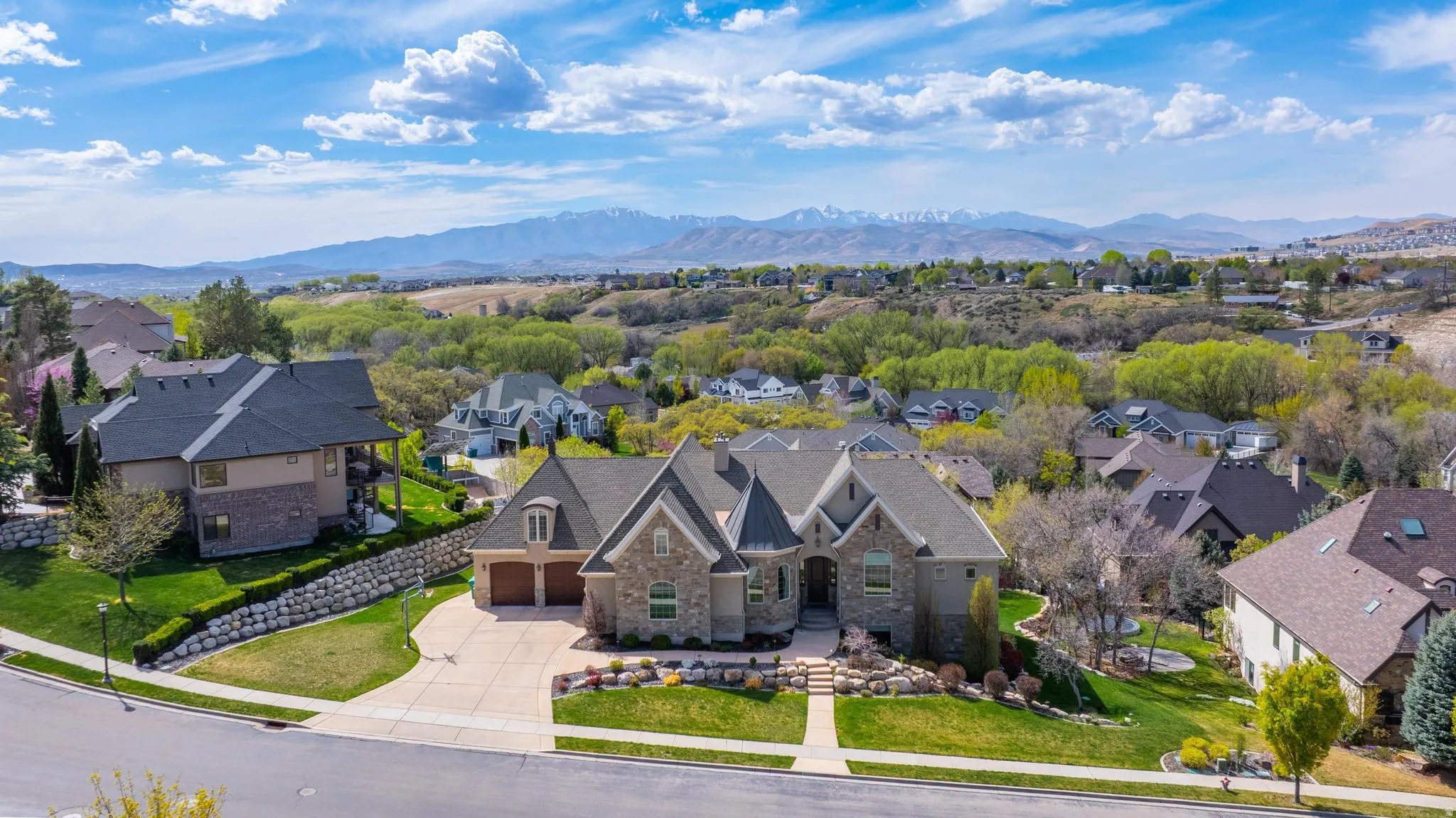 Aerial perspective of suburban area featuring a mountainous background