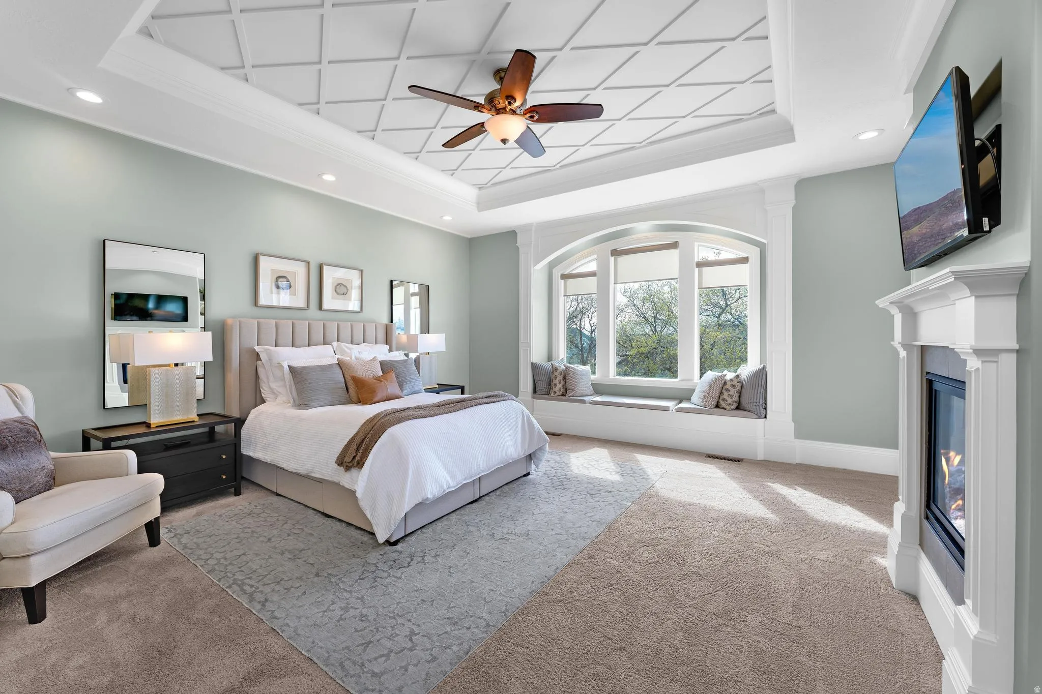 Bedroom with light carpet, recessed lighting, crown molding, ceiling fan, and a raised ceiling