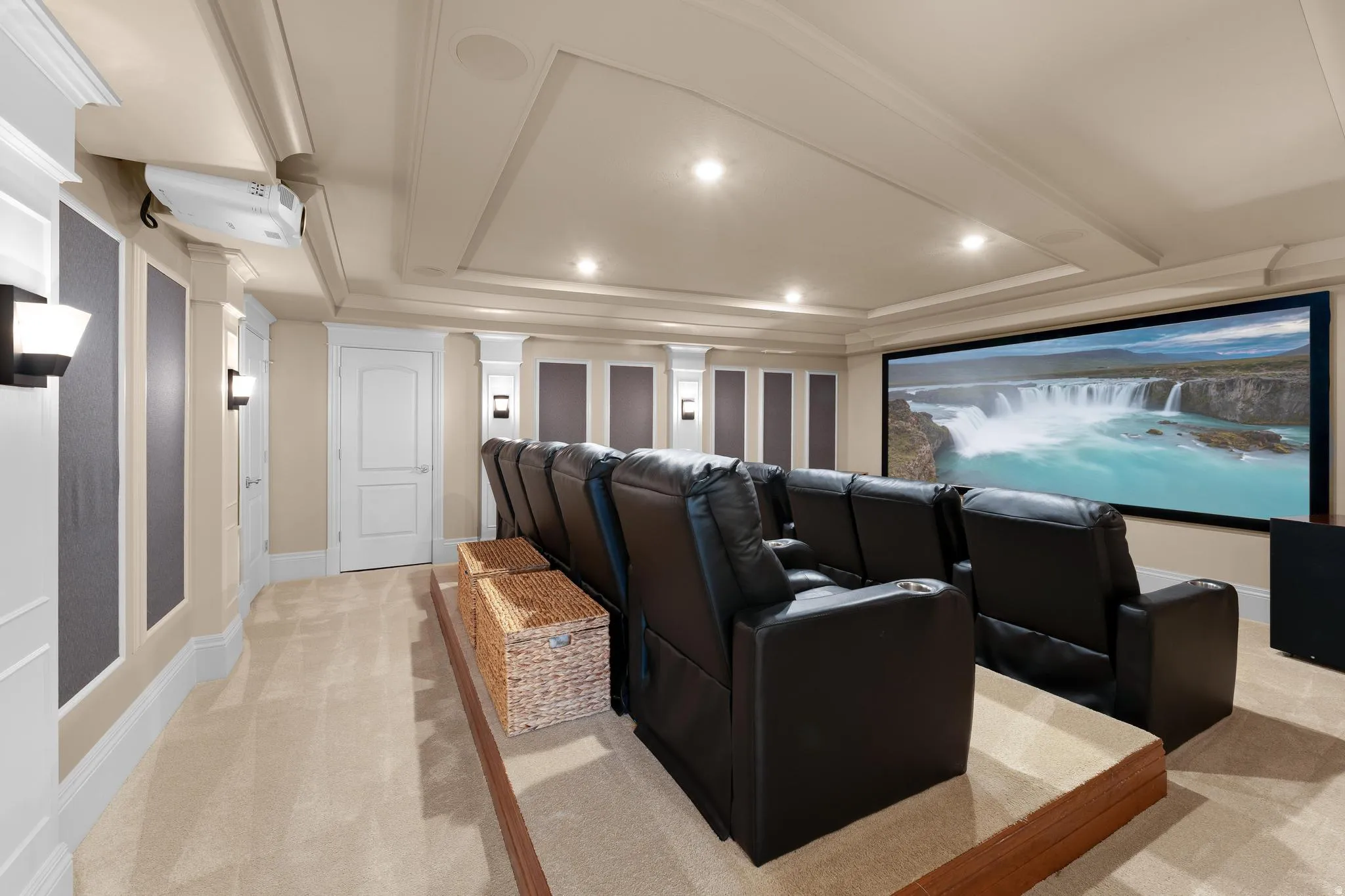 Home theater room featuring light carpet, recessed lighting, and a raised ceiling
