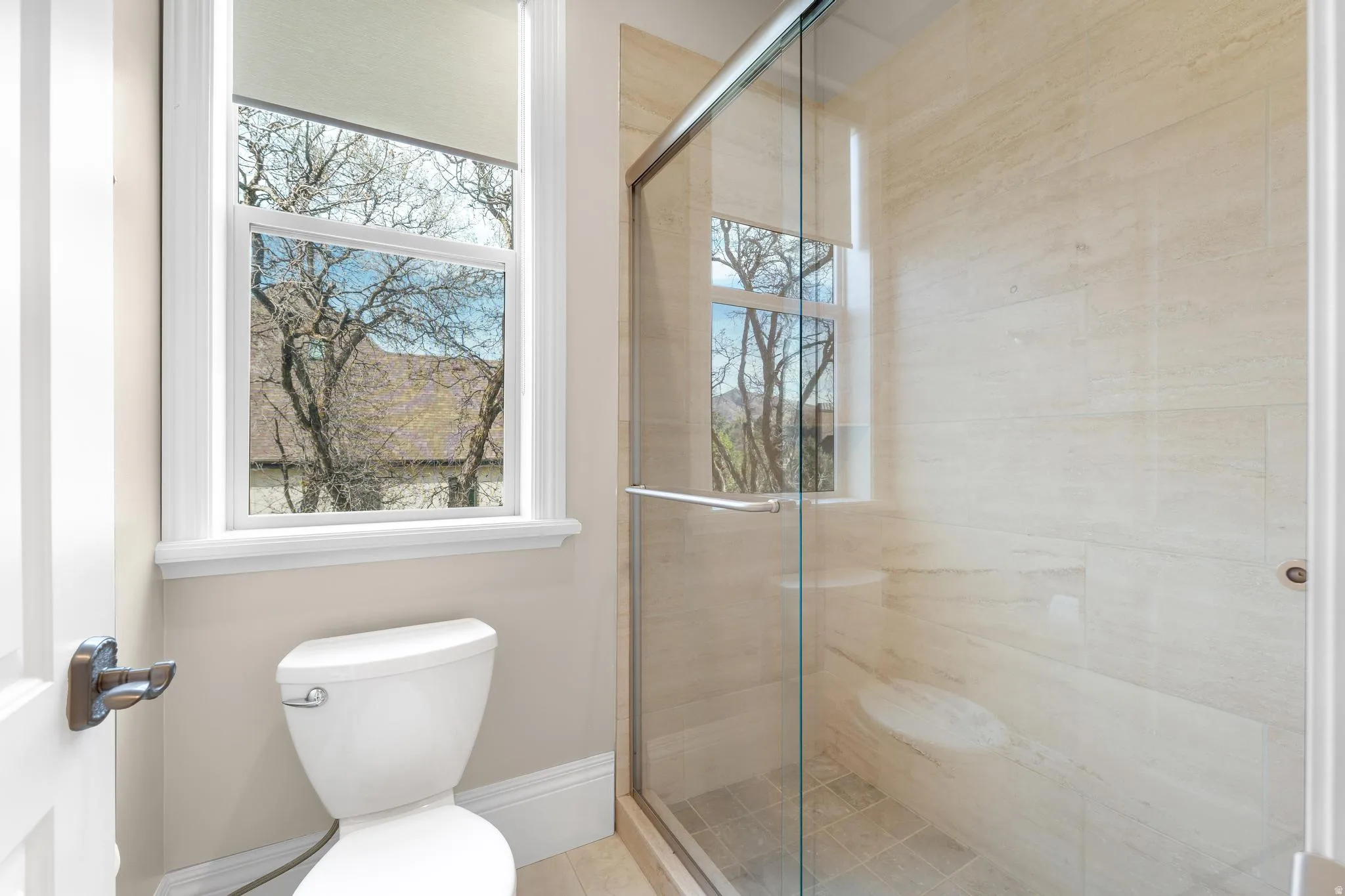 Bathroom featuring a stall shower and healthy amount of natural light