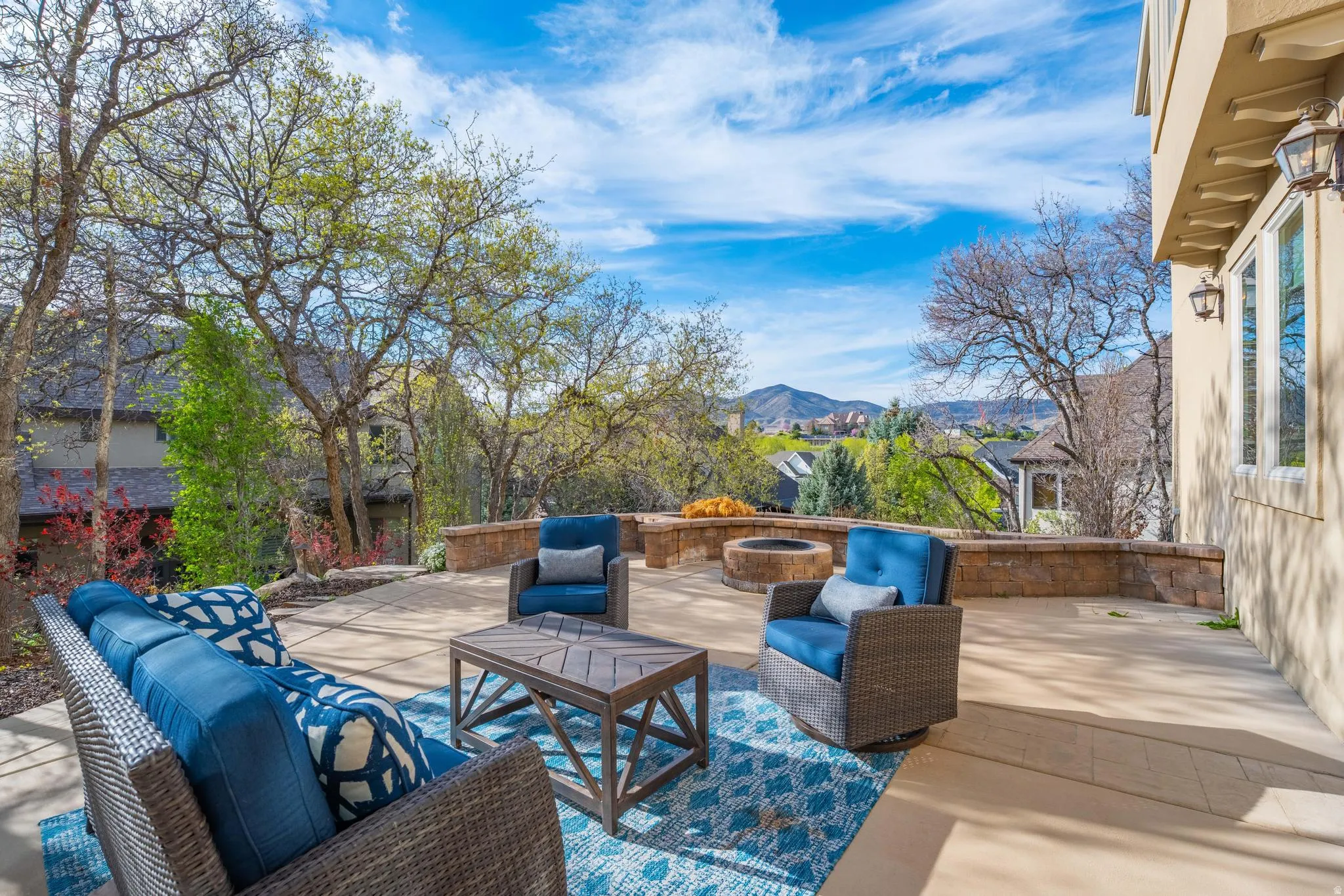 View of patio with an outdoor living space with a fire pit and a mountain view