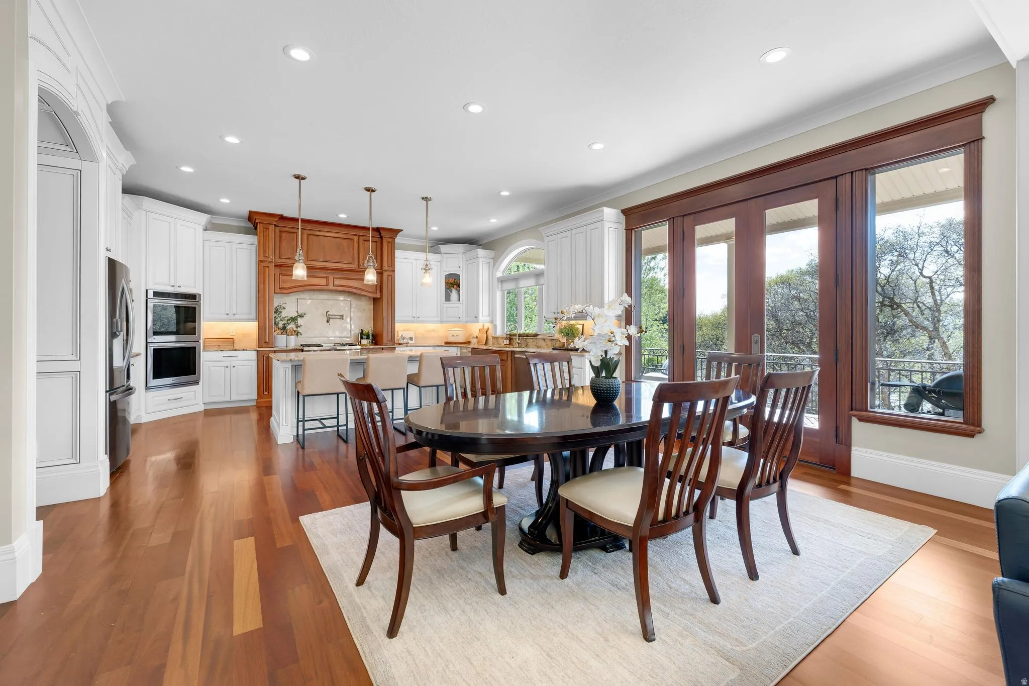 Dining room featuring dark wood-type flooring, recessed lighting, ornamental molding, and french doors