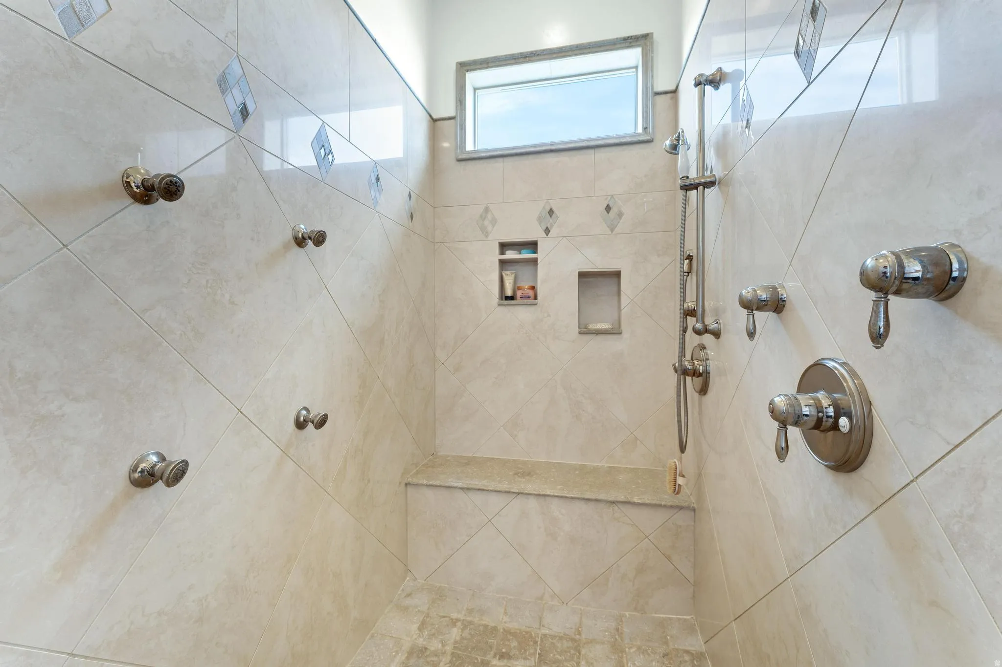 Full bath featuring tiled shower