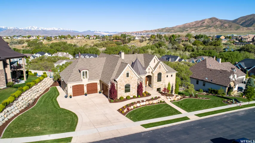 Stunning stone and stucco exterior with a prominent turret entry