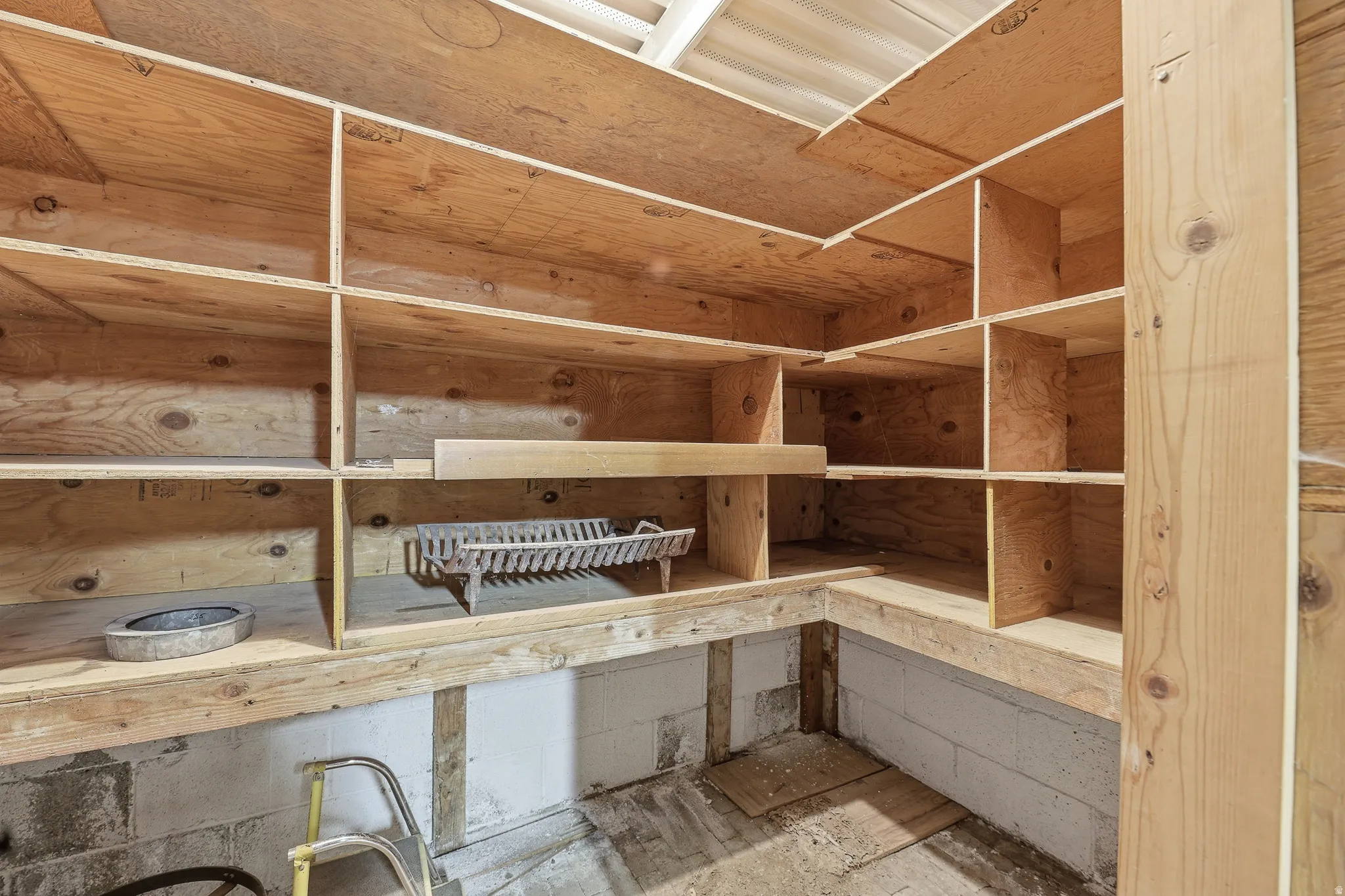 Extensive custom shelving constructed from plywood offers substantial storage capacity
