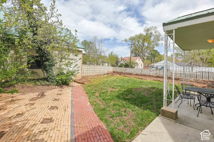 Fenced backyard featuring outdoor dining space and a patio
