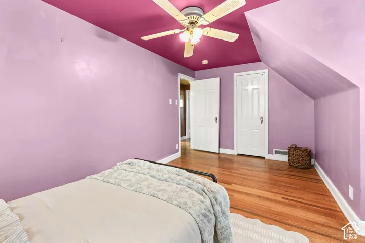 Bedroom 2 with hardwood lofted ceiling, and a ceiling fan