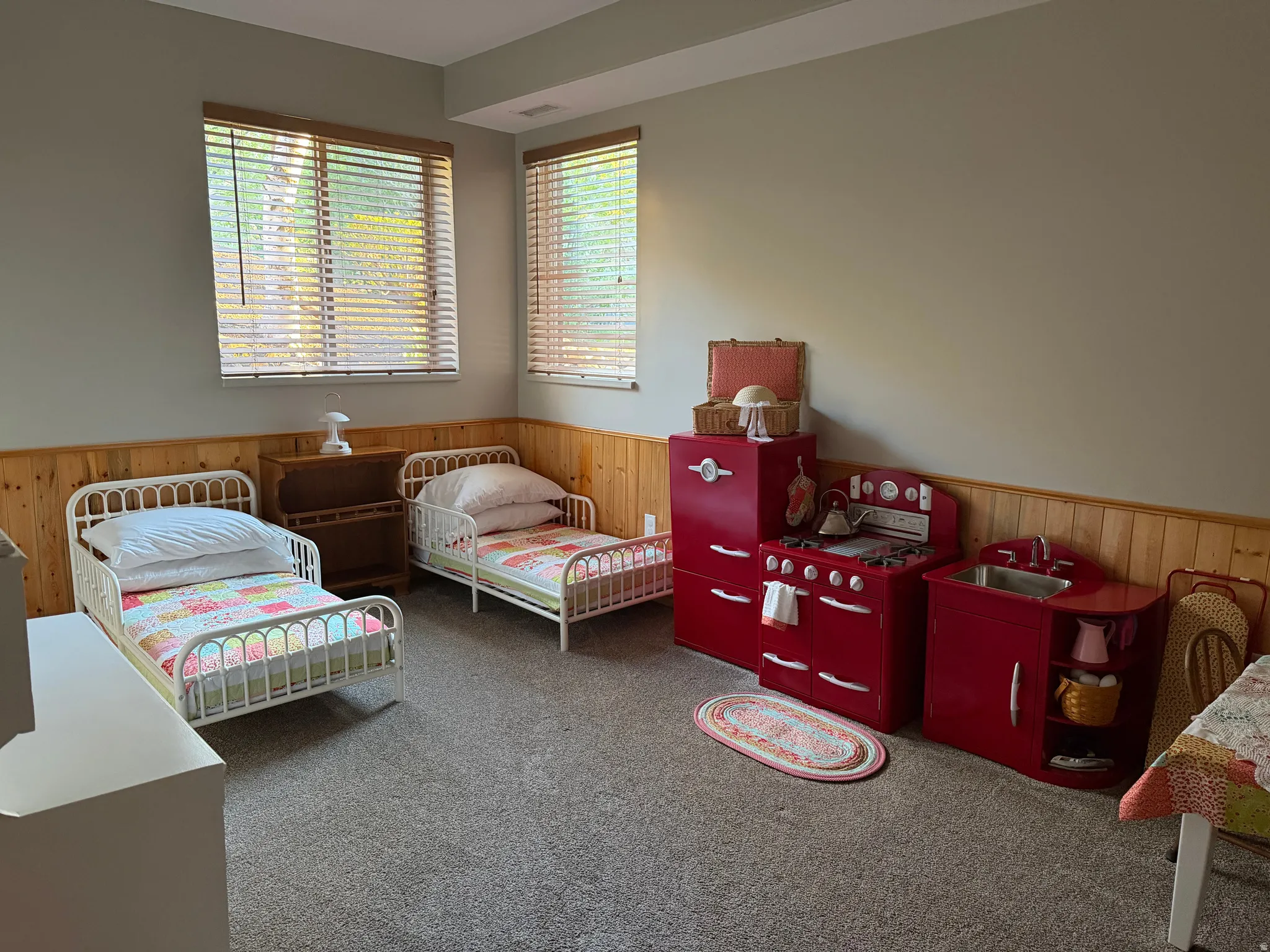 Bedroom with wooden walls, carpet, and wainscoting