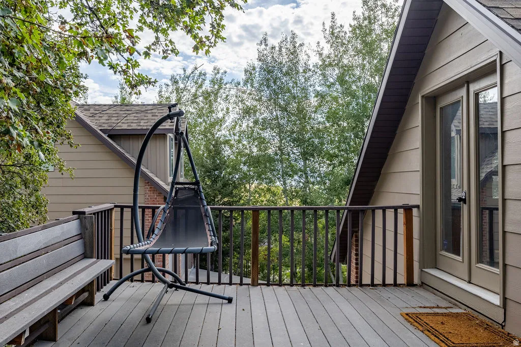 Outdoor deck with composite plank flooring and dark wood railing