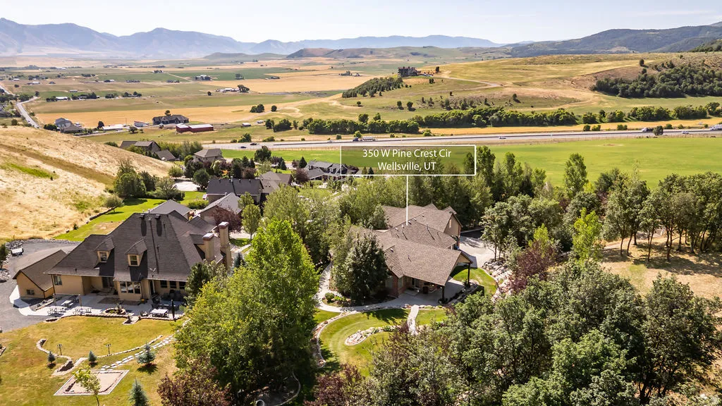 Expansive property featuring multiple structures, mature trees, and manicured lawns