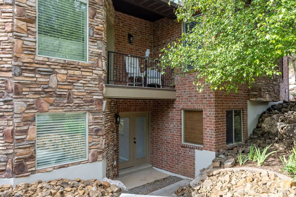 Multi-level exterior featuring natural stone and brickwork