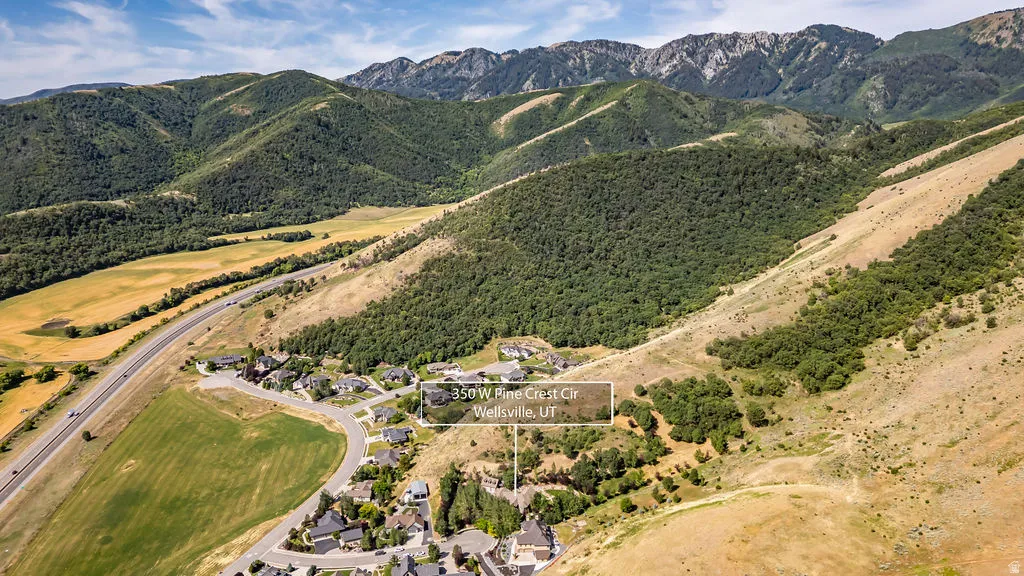 Aerial perspective showcasing a residential area nestled at the base of mountains