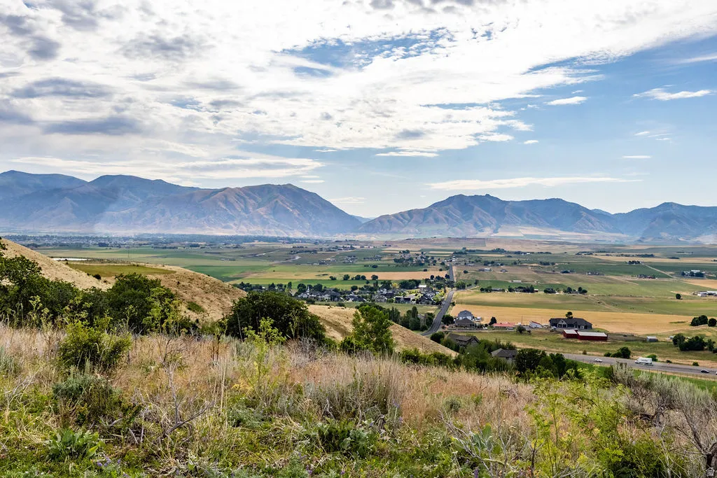 Expansive mountain backdrop with a foreground of rolling hills