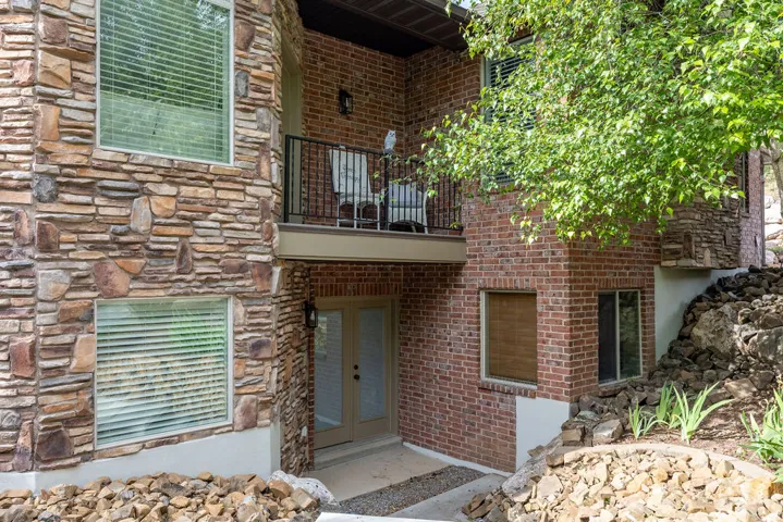 Multi-level exterior featuring natural stone and brickwork