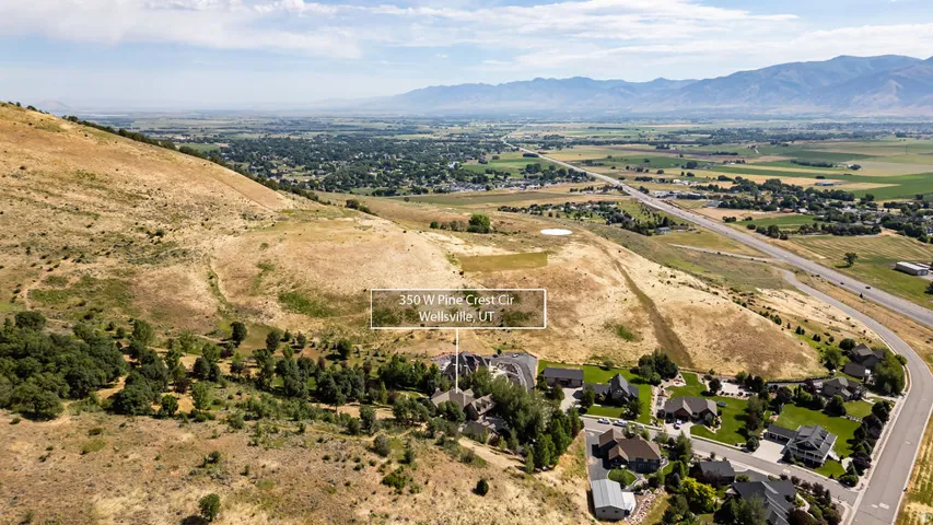 Expansive hillside property with sweeping valley and distant mountain backdrops