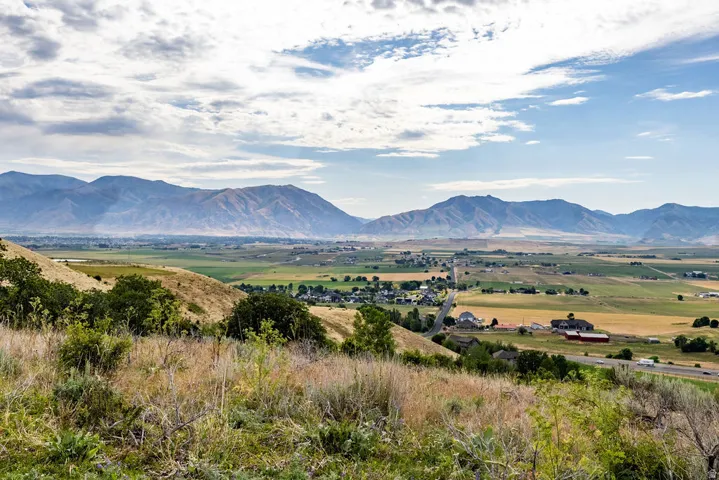 Expansive mountain backdrop with a foreground of rolling hills