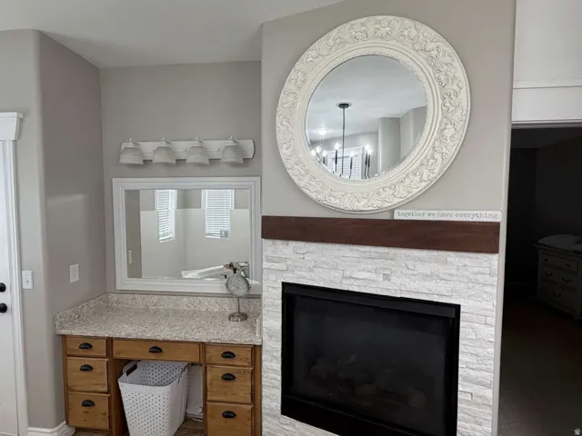 Bathroom featuring vanity and a stone fireplace