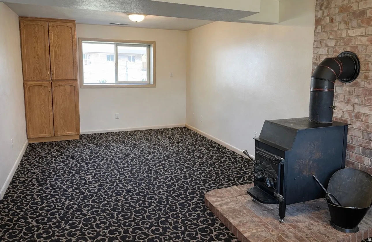 Detailed view of a wood stove and carpet flooring