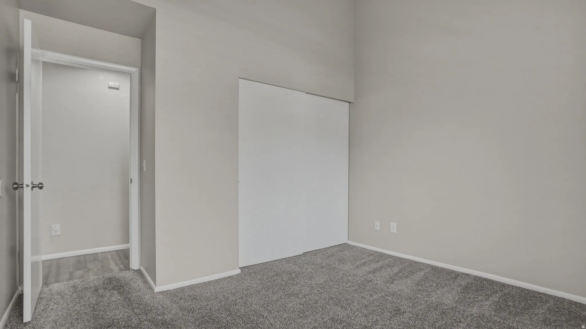 Unfurnished bedroom featuring carpet and a closet