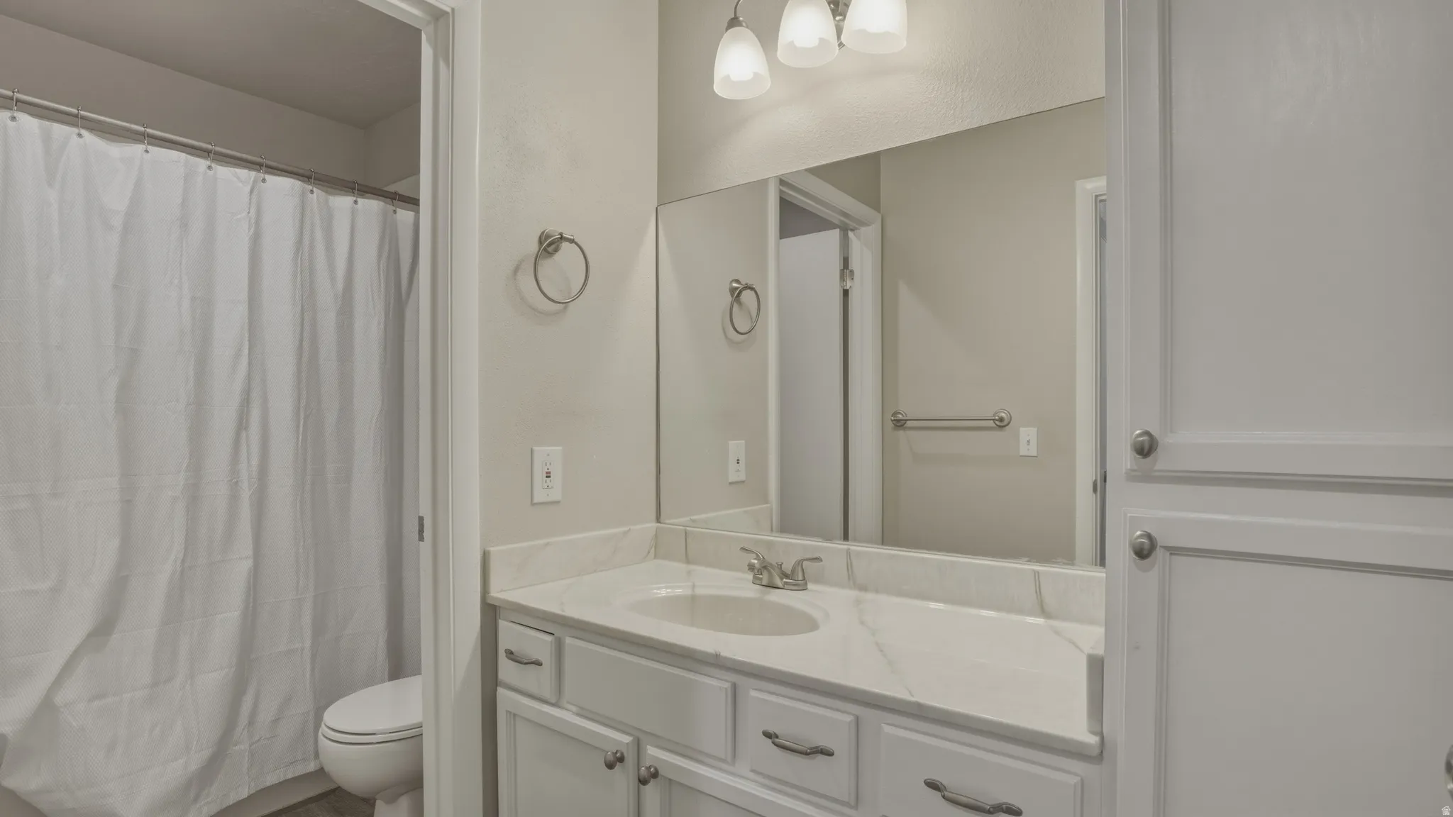 Bathroom featuring vanity and a shower with shower curtain
