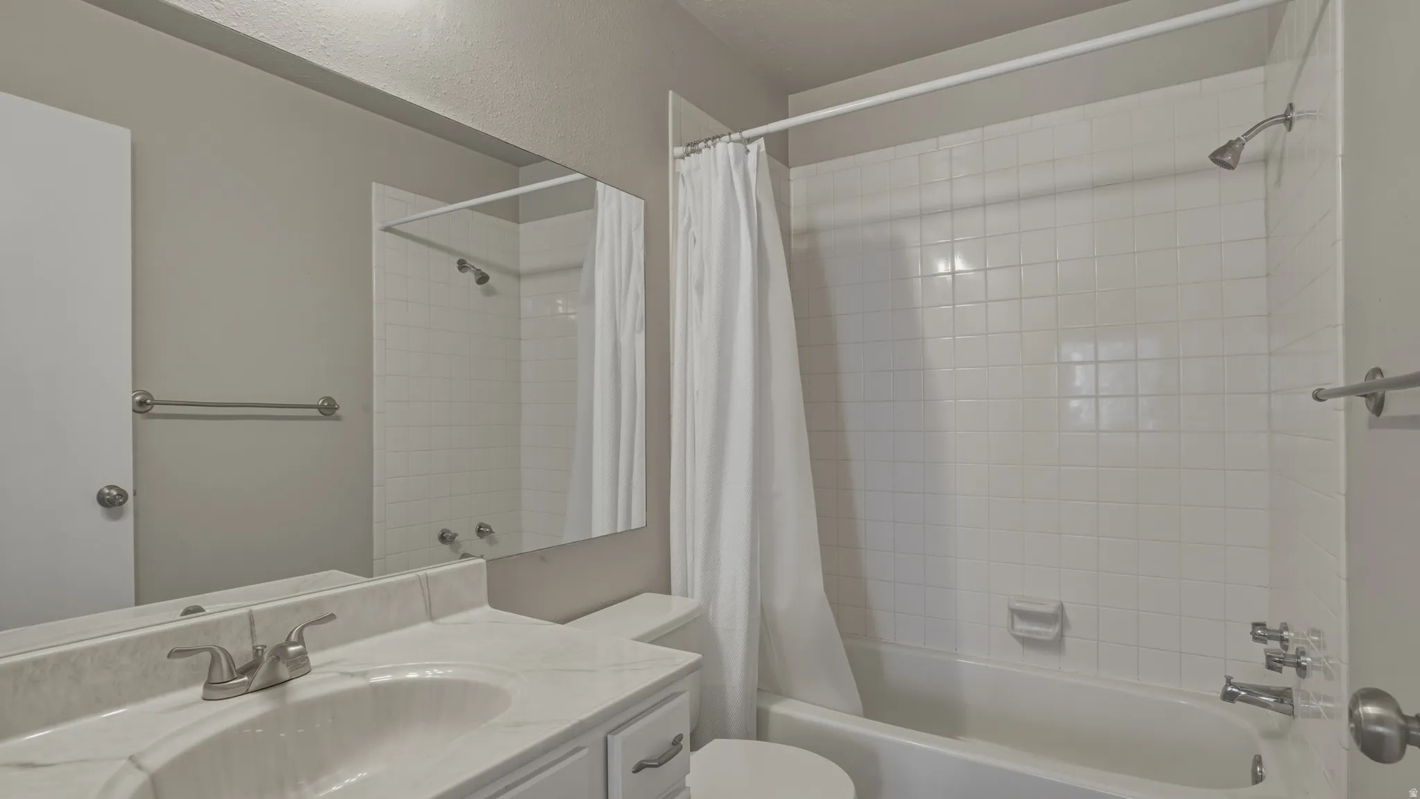Bathroom with shower / tub combo with curtain and vanity