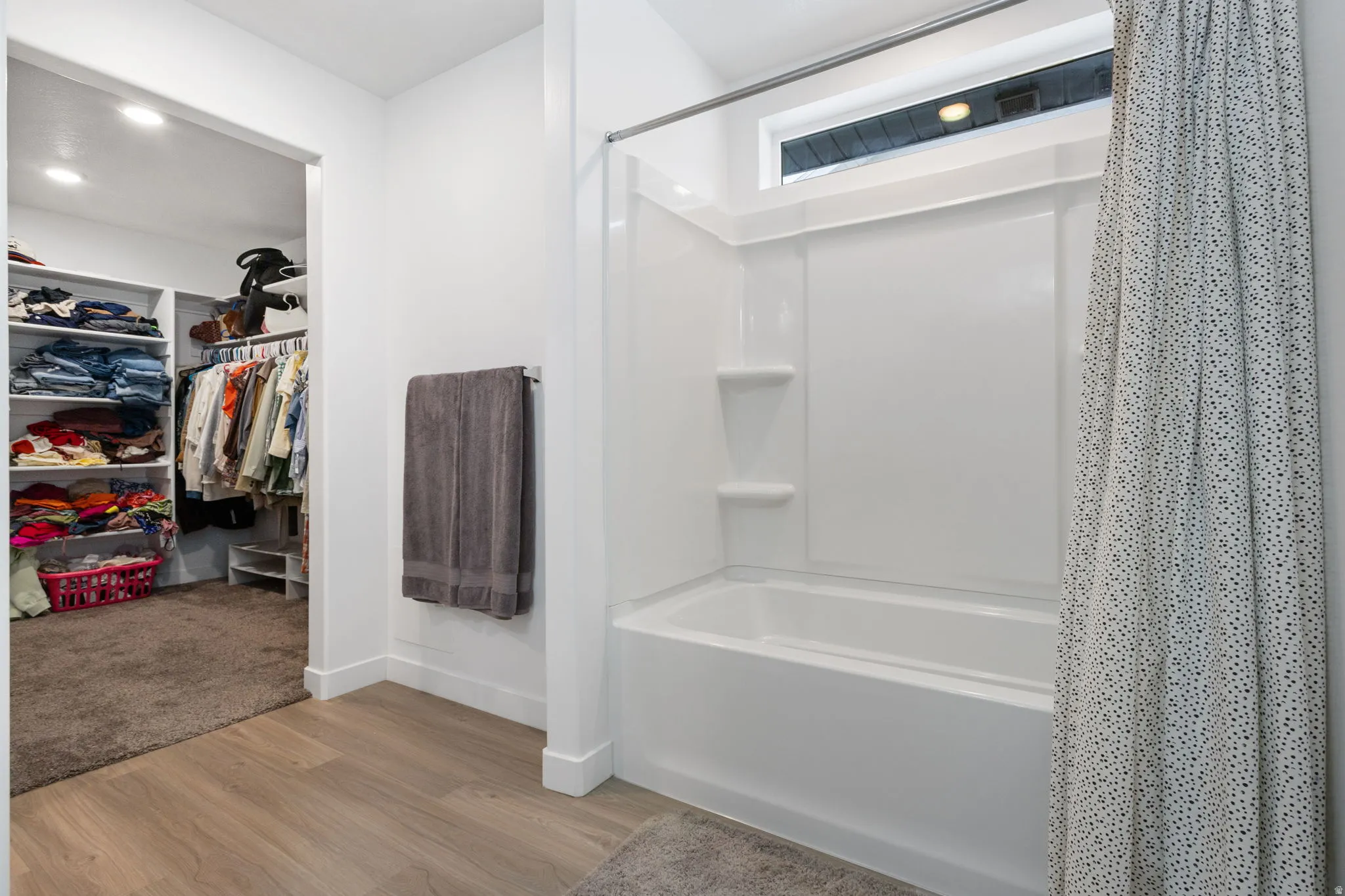 Primary bathroom with a large walk in closet